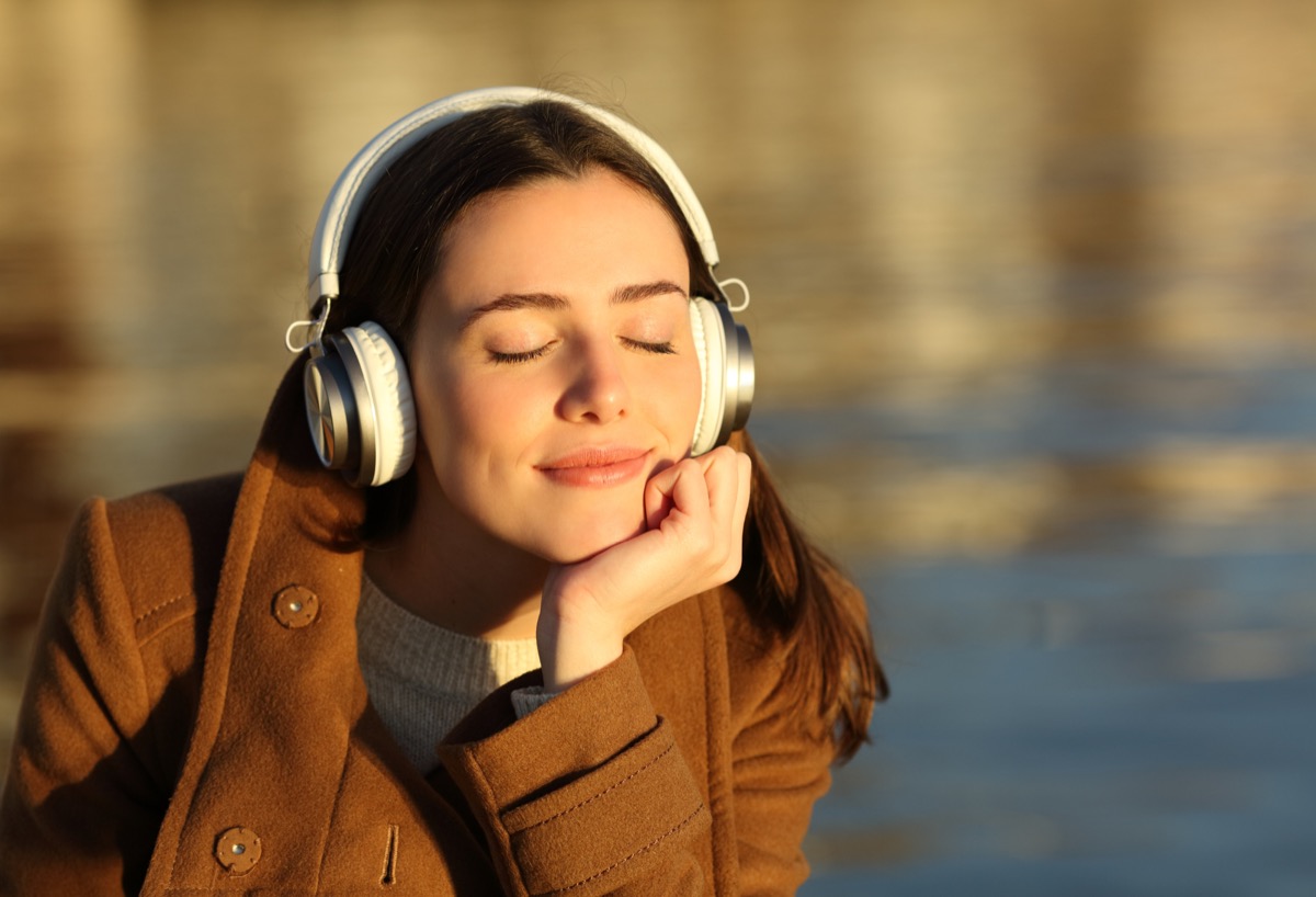 Woman relaxing with earbuds, calm and in control — Mochi Zen hypnotherapy